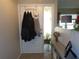 Inviting entryway with a white front door, sidelight window and convenient coat rack at 2475 Wood Oak Dr, Sarasota, FL 34232