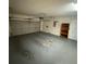Spacious two-car garage with painted floor, shelving, and automatic door opener ready for your vehicles or storage at 2475 Wood Oak Dr, Sarasota, FL 34232