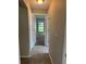 Hallway view of the bedroom featuring carpet, a window, and cream-colored walls at 2475 Wood Oak Dr, Sarasota, FL 34232