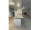 Updated kitchen with granite countertops and stainless steel appliances open to the living area at 2475 Wood Oak Dr, Sarasota, FL 34232