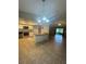Updated kitchen with granite countertops and stainless steel appliances open to the living area at 2475 Wood Oak Dr, Sarasota, FL 34232