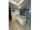 Bright kitchen island with white cabinetry and granite countertops, perfect for food prep and entertaining guests at 2475 Wood Oak Dr, Sarasota, FL 34232