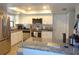 Modern kitchen with stainless steel appliances, granite countertops, and white cabinets at 2475 Wood Oak Dr, Sarasota, FL 34232