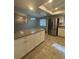 Updated kitchen with stainless steel appliances, granite counters, white cabinets, and stylish tile flooring at 2475 Wood Oak Dr, Sarasota, FL 34232