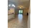 Open-concept living room features tile floors, a fireplace, and sliding glass doors to the outdoor patio at 2475 Wood Oak Dr, Sarasota, FL 34232