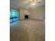 Bright living room featuring neutral tile flooring, a fireplace, and sliding door access to the screened patio at 2475 Wood Oak Dr, Sarasota, FL 34232