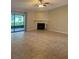 Spacious living room showcasing a fireplace, tile flooring, and lots of light from the screened in patio at 2475 Wood Oak Dr, Sarasota, FL 34232