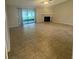 Inviting living room with tile flooring, a cozy fireplace, and sliding glass doors leading to an outdoor patio at 2475 Wood Oak Dr, Sarasota, FL 34232