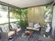 Relaxing screened lanai with comfortable seating, providing a perfect outdoor living space with plants at 2475 Wood Oak Dr, Sarasota, FL 34232