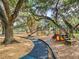 Community playground with modern equipment, slides, and climbing apparatus for outdoor fun at 2475 Wood Oak Dr, Sarasota, FL 34232