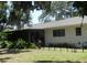 Back of house showing screened porch and fenced area at 2475 Wood Oak Dr, Sarasota, FL 34232