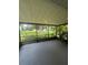 View of the screened patio with a ceiling fan and a view of the backyard at 2475 Wood Oak Dr, Sarasota, FL 34232