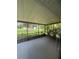 View of the screened patio with a ceiling fan and a view of the backyard at 2475 Wood Oak Dr, Sarasota, FL 34232
