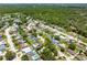Wide aerial shot displaying the house within a community featuring mature landscaping and neighborhood streets at 2630 Bucida Dr, Sarasota, FL 34232