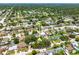 Community aerial shot displaying the house's position within a lush, residential area with mature trees at 2630 Bucida Dr, Sarasota, FL 34232