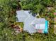 Overhead shot of home highlighting the metal roof and backyard pool surrounded by tropical trees at 2630 Bucida Dr, Sarasota, FL 34232