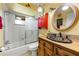 Bathroom featuring a single sink vanity, vibrant color scheme, and shower-tub combo at 2630 Bucida Dr, Sarasota, FL 34232