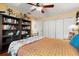 Comfortable bedroom featuring built-in shelving, wood floors, and a large closet at 2630 Bucida Dr, Sarasota, FL 34232