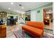 Bonus room with an orange sofa, closet, and a workspace, ideal for a home office at 2630 Bucida Dr, Sarasota, FL 34232
