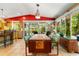 Dining area with pool and backyard views plus kitchen access via breakfast bar at 2630 Bucida Dr, Sarasota, FL 34232