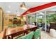 Bright dining area features pool view, kitchen access, decorative lighting, and seating for six at 2630 Bucida Dr, Sarasota, FL 34232