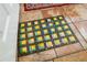 Unique mosaic tile accent rug on tan tile floor adds character to this home's interior design at 2630 Bucida Dr, Sarasota, FL 34232