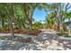 Lovely home with mature trees, lush landscaping, and a brick driveway at 2630 Bucida Dr, Sarasota, FL 34232