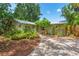 Charming single-story home with a brick walkway, lush landscaping and a well-manicured front yard at 2630 Bucida Dr, Sarasota, FL 34232