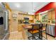 Kitchen featuring an island, wood cabinets, stainless steel appliances and tile floors at 2630 Bucida Dr, Sarasota, FL 34232
