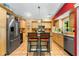 Kitchen with stainless steel appliances and an island with bar stool seating at 2630 Bucida Dr, Sarasota, FL 34232