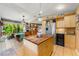 Spacious eat-in kitchen featuring an island, stainless steel appliances, wine cooler and tile flooring at 2630 Bucida Dr, Sarasota, FL 34232