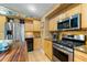 A gourmet kitchen boasts stainless steel appliances, a gas range, and granite countertops at 2630 Bucida Dr, Sarasota, FL 34232