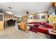 Eclectic living room with tile floors, unique furnishings and art, with ample natural light at 2630 Bucida Dr, Sarasota, FL 34232