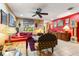 Bright living room featuring eclectic decor, including art, furniture, and a colorful rug at 2630 Bucida Dr, Sarasota, FL 34232