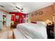 Bright main bedroom offers a cozy retreat with unique red accent wall and ample natural light at 2630 Bucida Dr, Sarasota, FL 34232