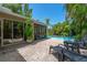 Step onto the brick patio to enjoy comfortable lounge chairs, a beautiful pool view, and lush tropical landscaping for outdoor relaxation at 2630 Bucida Dr, Sarasota, FL 34232