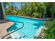 Sparkling pool with clear blue water and a convenient handrail for easy access and safety at 2630 Bucida Dr, Sarasota, FL 34232