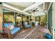 Entertain guests in the screened porch with ceiling fan, furniture, mini-fridge, and a view of the pool at 2630 Bucida Dr, Sarasota, FL 34232