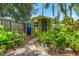 Backyard shed surrounded by lush plants and greenery offering a tranquil escape at 2630 Bucida Dr, Sarasota, FL 34232
