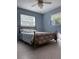 Light-filled bedroom with terrazzo floors, a gold metal bed frame, and two sunlit windows at 2833 62Nd N St, St Petersburg, FL 33710