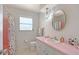 Bathroom features a stylish vanity with a large round mirror and decorative lighting at 3127 Dawson St, Sarasota, FL 34239