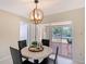 Dining area with sliding glass doors leading to a screened lanai and pool area at 3127 Dawson St, Sarasota, FL 34239