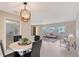 Cozy dining area with a modern chandelier and a view into the living room at 3127 Dawson St, Sarasota, FL 34239