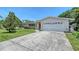 Single-story home featuring an attached garage, a well-manicured lawn, and mature landscaping at 3127 Dawson St, Sarasota, FL 34239