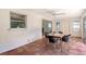 Enclosed patio featuring decorative terracotta tiled floor and black dining set at 3127 Dawson St, Sarasota, FL 34239