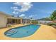 Backyard features a sparkling blue pool surrounded by a well-maintained deck and lush greenery at 3127 Dawson St, Sarasota, FL 34239