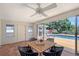 Sunroom with dining table, fan and outdoor views of the pool at 3127 Dawson St, Sarasota, FL 34239