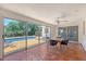 Bright sunroom with tile floor, dining table, and sliding glass doors to pool at 3127 Dawson St, Sarasota, FL 34239