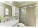 Updated bathroom features a modern vanity, marble countertop, and shower with glass door at 3213 Mercer Rd, Bradenton, FL 34207