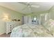 Bright bedroom featuring tropical bedding, a ceiling fan, and stylish coastal decorations at 3213 Mercer Rd, Bradenton, FL 34207